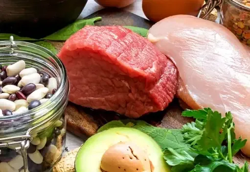 Beef, chicken, beans, egg and avocado on a board, everyday sources of niacin